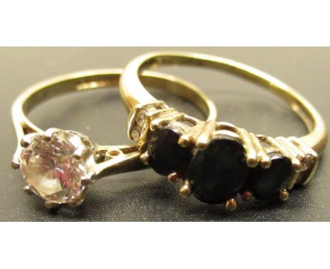 Continental gold three stone dark sapphire ring, stamped 10K, and a 9ct gold hallmarked single stone dress ring 3.1ox gross (