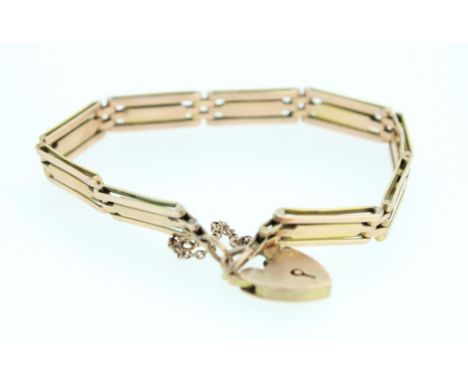 9ct yellow gold three bar gate bracelet with heart padlock clasp and safety chain, engraved date 23/11/35, stamped 9ct, 13.8g
