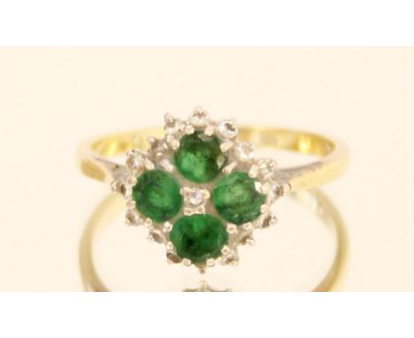 18ct yellow gold quatrefoil emerald and diamond cluster ring, the four brilliant cut emeralds surrounded by diamonds, stamped