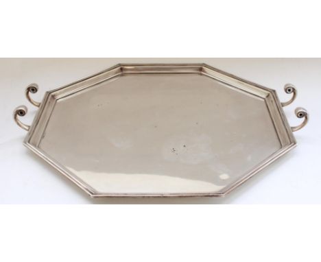 Geo.V hallmarked silver serving tray, of art deco octagonal shape with stepped border and C scroll handle mounts.  Sheffield 