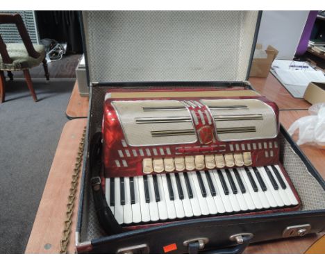 A Hohner Atlantic IV 120 button accordion, 11 register disca, 3 register bass, red pearlescent finish 