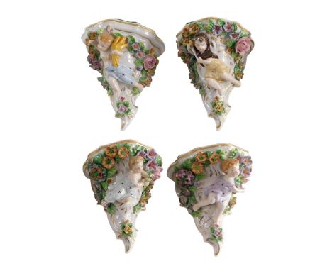 A set of four Sitzendorf porcelain flower encrusted brackets, each decorated with a figure, 12cm high. 