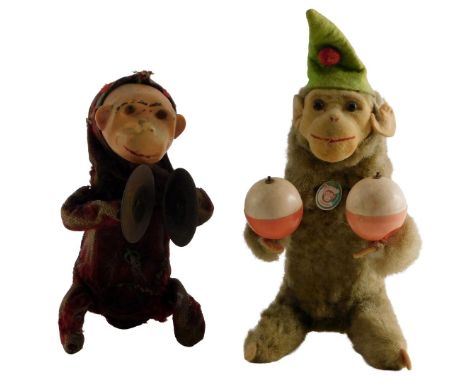A tinplate model of a monkey playing symbols, possibly German, and a later German monkey playing maracas. (2)