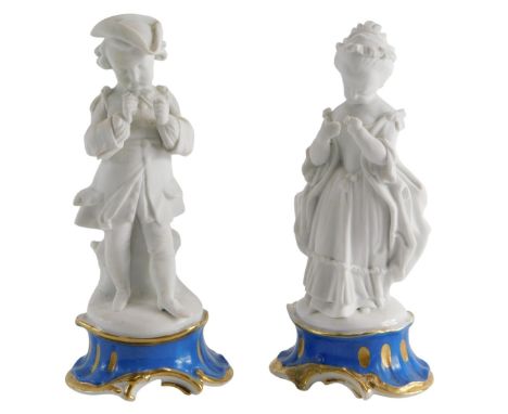 A pair of 19thC part bisque porcelain figures of a gentleman and lady, on turquoise glazed base, both with holster to the bac