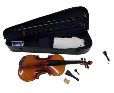 A German violin, bearing paper label Antonio Stradivarius, with two piece back, length of back 36cm, and two violin bows. 