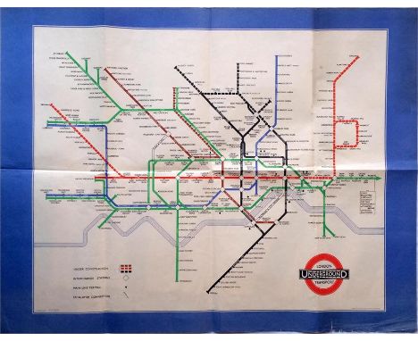 1939 London Transport Underground POSTER MAP designed by H C Beck and featuring a wide blue border. Shows the planned extensi