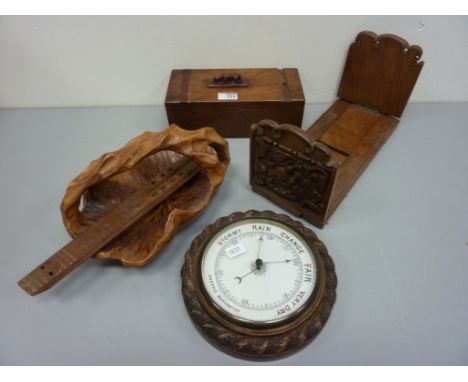Edwardian oak cased barometer, telescopic book stand, puzzle box, wooden basket and a carved wood instrument 