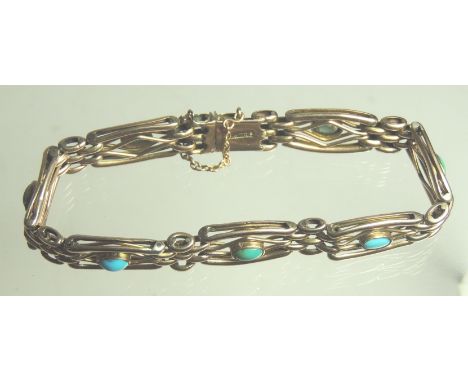 An early 20th Century, 9ct gold and turquoise set bracelet of four bar gate design, set with seven cabouchon turquoise. 15.9g