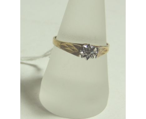 A 9ct gold, solitaire diamond ring.  Illusion set in a star surround with cage mount.  Size R +.  