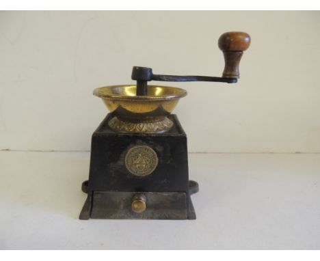 A late Victorian coffee grinder by Archibald Kenrick & Sons, with original wooden handle, 11cms high to top of brass bowl
