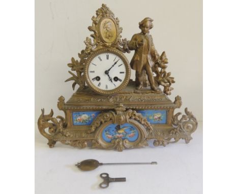 A 19th Century French mantel clock by Marti et Cie, in gilt metal case surmounted by portrait of a lady and her Beau standing