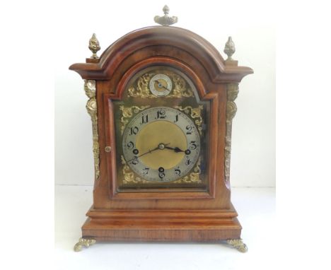 A Georgian style bracket clock in walnut case with gilt metal mounts and having silver metal chapter ring, Arabic numerals, r
