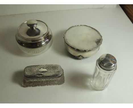 A silver and glass dressing table powder bowl, the lift off lid with interior mirror, a glass and silver jar with pull off li