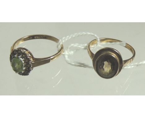 A ladies 9ct gold dress ring set with a central, oval, faceted citrine, Ring size N+ and another ladies 9ct gold dress ring, 