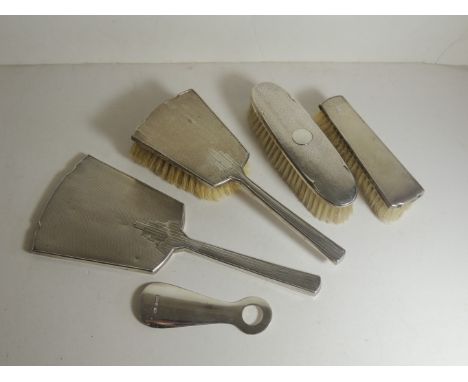 A silver mounted Art Deco, part dressing table set, comprising hand mirror, hair brush and clothes brush, another silver clot