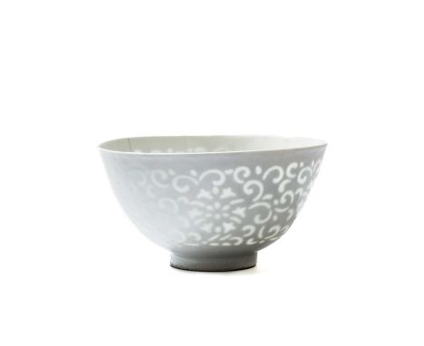 A RARE CHINESE WHITE-GLAZED 'OPEN-WORK' 'LOTUS' BOWL, QING DYNASTY (1644-1911) the deep rounded sides rising from a short str