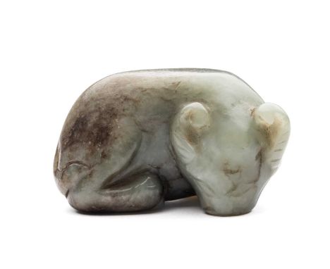 A CHINESE GREEN JADE BUFFALO, QING DYNASTY (1644-1911) carved recumbent with head turned sharply to the right, the stone of g