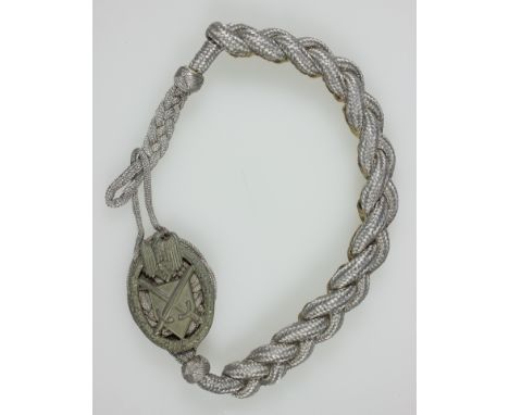 GERMAN ARMY MARKSMANSHIP LANYARDBraided silver metal cording with a zinc badge mounted to the top pad. Both attaching loops a