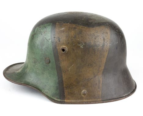 CAMOUFLAGE-PAINTED GERMAN M1916/1917 STAHLHELMSteel German M1916/1917 helmet, identifiable as such by the externally-visible 