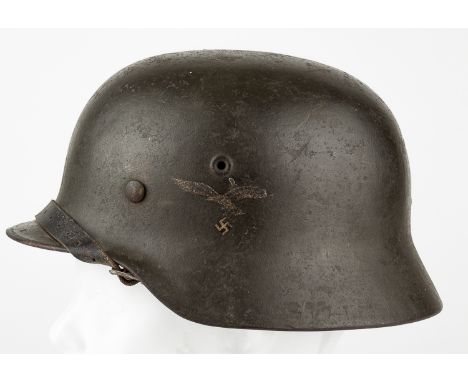 LUFTWAFFE M40 HELMETLuftwaffe M40 helmet, an uncommon dark green toned paint with heavily worn second pattern eagle and swast