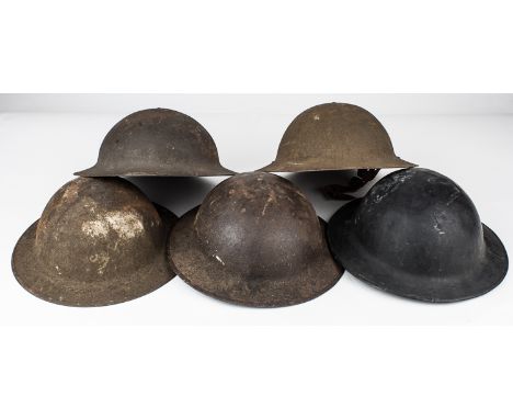 M1917 HELMETSGood group of five American steel M1917 helmets, as issued to troops during World War I. The group includes four