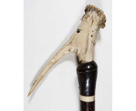 GROTESQUE ANTI-SEMITIC WALKING STICKWood walking stick, 37" long, with an approx. 6" head, carved from a deer antler, in a gr