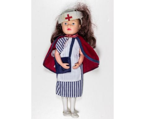 U.S. ARMY NURSE DOLLPlastic-bodied doll, 6 1/2" tall, with brown synthetic hair, dressed in a well-executed replica of a Worl