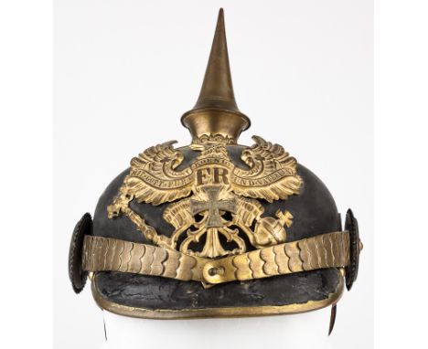 PRUSSIAN PICKELHAUBEWorld War I-era German "Pickelhaube", constructed of lacquered black leather, with a brass circular plate