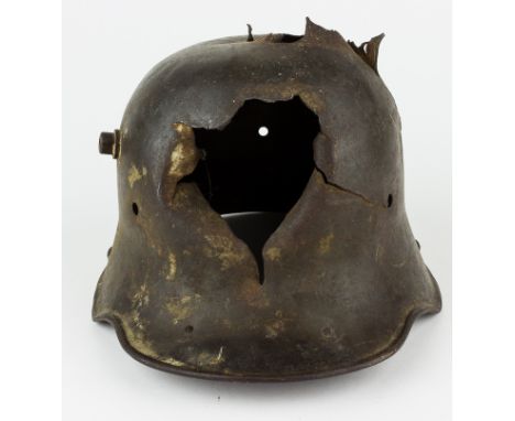 SHRAPNEL-STRUCK GERMAN M1916/1917 HELMETAn especially evocative World War I relic, a German M1916/1917 "Stahlhelm"-style helm