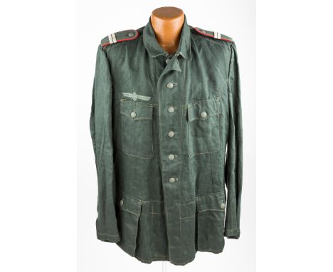 WEHRMACHT TUNIC WITH COSSACK INSIGNIAUnissued dark green summer work uniform of herringbone tweed, with four patch pockets on