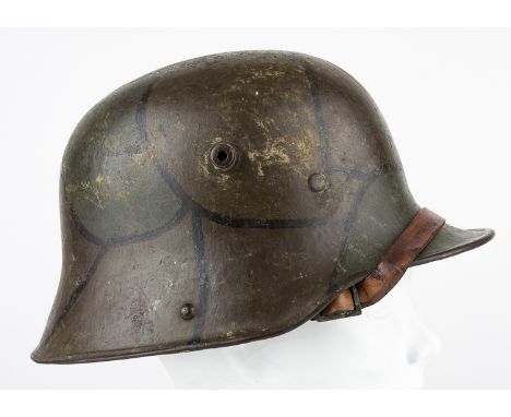 CAMOUFLAGE-PAINTED M1916/1917 STAHLHELMGerman steel M1916/1917 combat helmet, identifiable as such by the detachable leather 