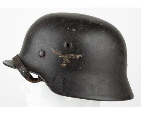 LUFTWAFFE M40 HELMETLuftwaffe M40 helmet, original very dark blue-gray paint with well-worn second pattern eagle and swastika