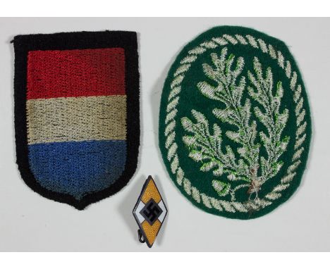 GERMAN INSIGNIALot of three pieces, includes: Jager cloth arm patch; Dutch Waffen-SS sleeve patch; and an enameled Hitler You