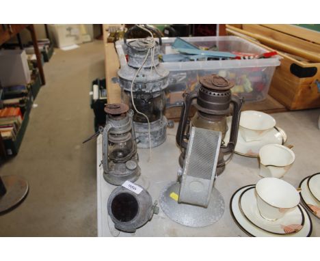 A ships lamp, two Tilley lamps and a vintage microphone