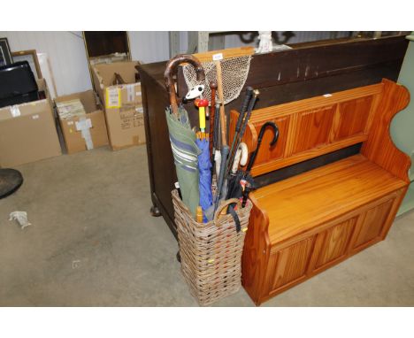 A wicker stick stand and contents of umbrellas and parasols