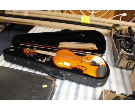 A case containing a violin and bow together with a recorder