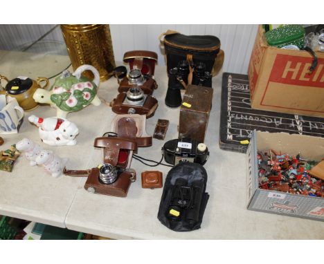 A pair of Prinz 12x50 binoculars, a Petie camera and various vintage cameras