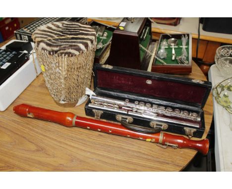 A Boosey & Hawkes silver plated flute, a recorder and a drum