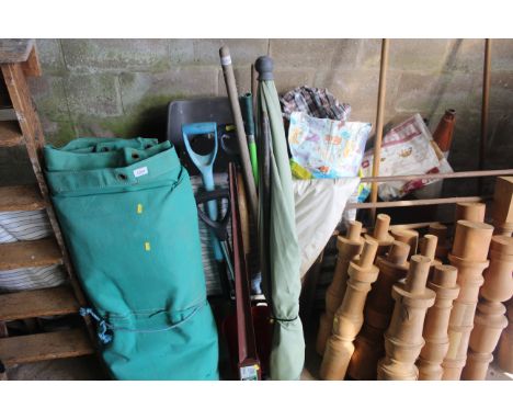 A quantity of long handled garden tools to include shovels, digging fork, rake, a two piece parasol and a garden Metpost 