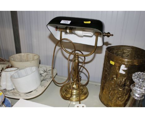 A desk lamp with green glass shade