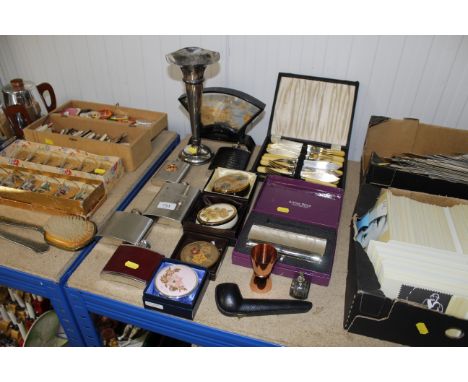 A collection of metal ware including spill vase, fish knives and forks, hip flasks and a cased pipe