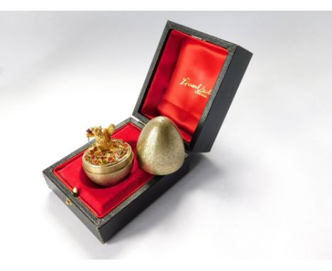 STUART DEVLIN. A Stuart Devlin, textured silver gilt Surprise Egg, opening to reveal a squirrel holding an enamelled flower, 