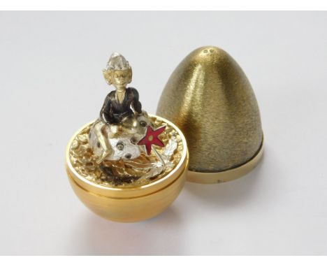 STUART DEVLIN. A Stuart Devlin silver & silver gilt Surprise Egg, opening to reveal a gnome sitting on a toadstool behind a r