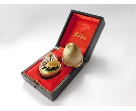 STUART DEVLIN. A Stuart Devlin textured silver gilt Surprise Egg, opening to reveal a silver gilt hedgehog beneath a flowerin