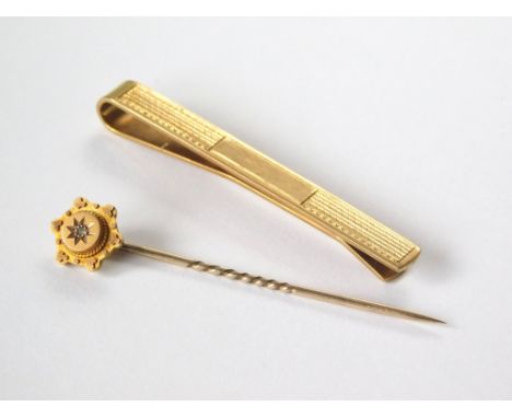 STICK PIN ETC. A 9ct. gold stick pin with gypsy set diamond & a 9ct. gold engine turned tie clip. Gross weight approx. 7.9g. 