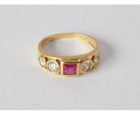 DRESS RING. A contemporary yellow metal dress ring, set a square cut synthetic ruby & collet set cubic zirconia. Two unidenti