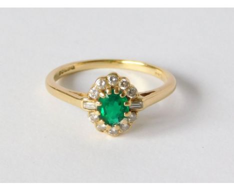 EMERALD RING. An 18ct. gold emerald cluster ring, the enamel surrounded by old & baguette cut diamonds. Size M. Approx. 2.6g.