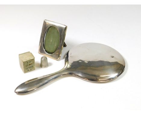 HAND MIRROR ETC. A plain silver mounted hand mirror, a small silver mounted photograph frame & a silver thimble, in thimble b