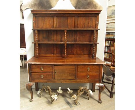 An 18th Century Continental oak dresser, bobbin-turned supports to plate rack back, four drawers and single cupboard door, ca