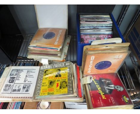 A case and four vintage record wallets containing a collection of 7" singles 